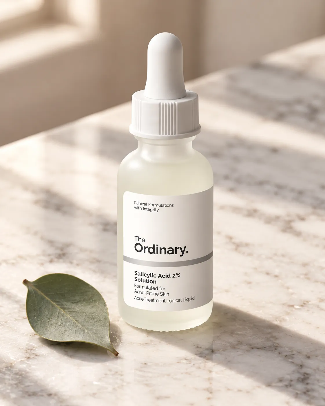 Amber glass dropper bottle on a marble surface with a single eucalyptus leaf beside it, soft natural window light, 45-degree angle, shot on a 85mm lens at f/4, calm spa-like mood, warm neutral color grade, commercial product photography, 4:5.